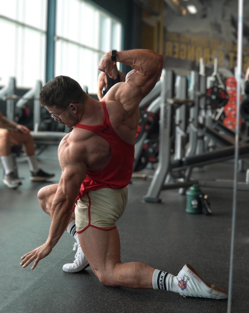 Coach is posing in the gym.